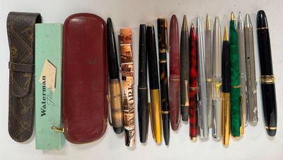 many pens and pencils lined up on a table
