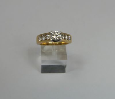 a close up of a gold ring with three diamonds on it