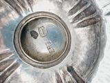a silver plate with a design on it on a table