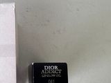 a box of perfume sitting on a table next to a box of lipstick
