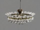 a glass chandelier with a bird on top of it