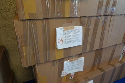 une pile de cartons posée sur un sol bleu