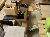 many boxes of wine sitting on the floor in a warehouse