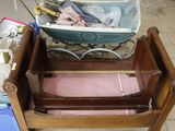 a baby ' s bed with a wooden frame and a baby ' s stroller