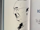 a book with a drawing of a man in a suit and tie