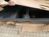 a person that is putting some doughnuts in a box