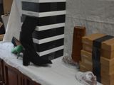 a table with several boxes and a pair of shoes on it