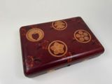 a small red box with gold designs on it