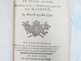 an open book with a picture of a coat of arms on top of it