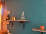 two shelves with vases on them in the corner of a room