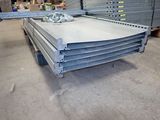 a pile of steel plates stacked on top of each other in a warehouse
