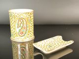 a cup and plate sitting on a black table