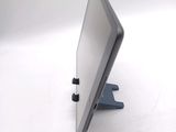 a computer monitor sitting on a stand on a white surface