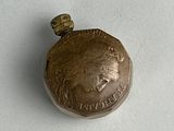 a small silver coin with a picture of a woman on it