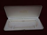 an open box with a necklace and bracelet inside of it