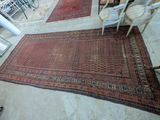 a rug on the floor next to a table and chairs