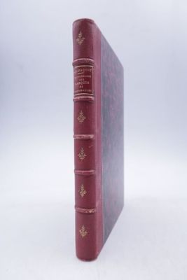 an old book sitting on top of a white table next to a white wall