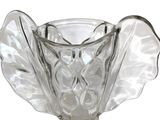a clear glass vase with a leaf design on it