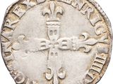 an old silver coin with a cross on it