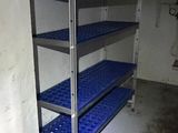 a blue shelf in the corner of a room