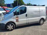 a silver van that is parked in a parking lot
