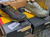 two pairs of shoes sitting on top of a box