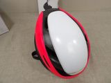 a helmet that is sitting on the floor next to a wall