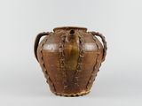 an old brown vase with handles on a white surface