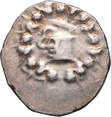 a silver coin with a face on it on a white background