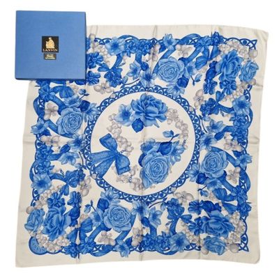 a blue and white handkerchief with blue flowers and butterflies on it