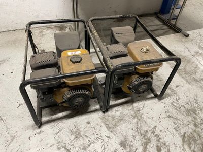 two small generators that are sitting on the floor