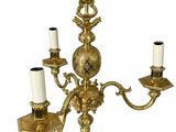 an image of a golden chandelier with three candles on it