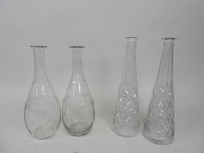 three clear glass vases sitting next to each other on a white surface