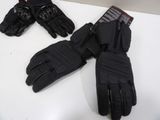 pair of black motorcycle gloves sitting on top of a white table