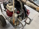 an image of a small machine with a hose attached to it