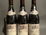 three bottles of wine sitting on top of a table next to each other