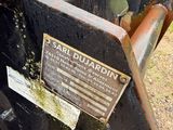 a sign on the back of a tractor that is parked in the dirt