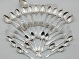 a group of silver spoons and forks arranged in a circle