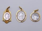 three gold and silver pendants with a picture of a woman in a frame