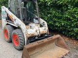 a small tractor that is parked on the side of the road