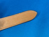 leather belt on a blue cloth with a brown leather buckle