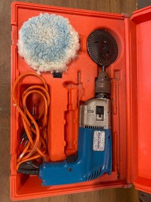 an orange box with a blue and red drill and a blue and white brush