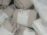 a pile of blankets and blankets wrapped in plastic bags
