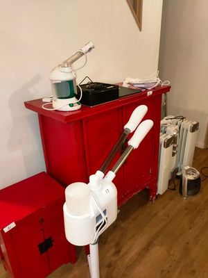 une armoire rouge et un ventilateur blanc dans une pièce