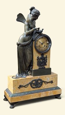 une statue de femme assise au sommet d'une horloge