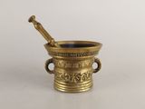 an antique brass mortar with a pestula in it on a white surface