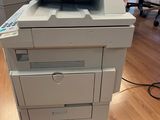 a white printer sitting on top of a wooden floor