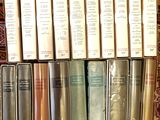 a lot of books that are sitting on a rug