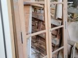 a wooden cabinet with a glass door in the middle of it
