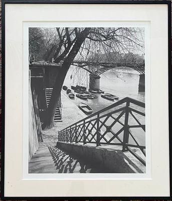 a black and white photo of boats on the water